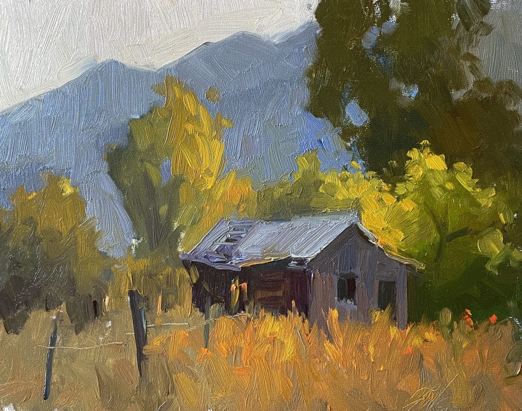 A photo of an original oil painting on panel of a landscape painting of a old shed in the mountains.