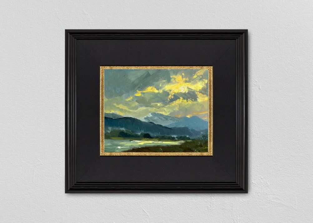 Experience the breathtaking beauty of a 8x6 inch landscape oil painting by Kelli Folsom, featuring a blue mountain range illuminated by sunlight breaking through the clouds. Painted in Folsom's distinctive loose style, this artwork captures the majestic essence of the mountains with expressive brushstrokes and dramatic lighting. The interplay of light and shadow adds depth and atmosphere, making this painting a stunning addition to any space, celebrating the awe-inspiring beauty of nature.
