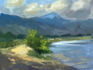 Experience the tranquil beauty of a 8x6 inch landscape oil painting by Kelli Folsom, featuring a scenic walking path with a backdrop of majestic blue mountains and serene blue water. Painted in Folsom's distinctive loose style, this artwork captures the serene essence of the natural scene with expressive brushstrokes and harmonious hues. The composition invites viewers to embark on a journey through the picturesque landscape, making it a captivating addition to any space that celebrates the splendor of nature.