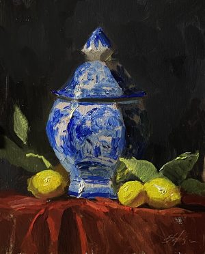 Enhance your decor with an 8x10 inch still life oil painting by Kelli Folsom, featuring a blue and white ginger jar with lemons on a tabletop draped in red velvet fabric. Painted in Folsom's loose, painterly style, this artwork captures the rich, dark values and textures with expressive brushstrokes. The composition adds a touch of classic elegance and vibrant color to any space, celebrating the timeless appeal of still life art.