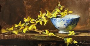 Oil painting of vibrant yellow forsythia branches arranged beside a delicate blue and white porcelain bowl, set against a warm brown background on a wooden surface.