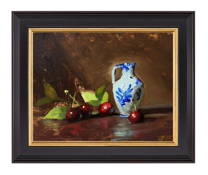 Still life oil painting of a white Delft-style pitcher with blue floral design, surrounded by ripe red cherries and green leaves on a dark wood surface.