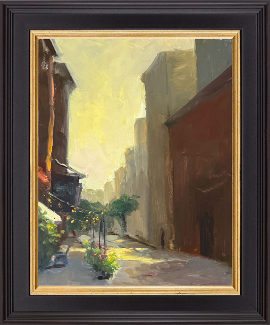An atmospheric oil painting of a sunlit city street at golden hour, with string lights, potted flowers, and distant figures beneath towering buildings.