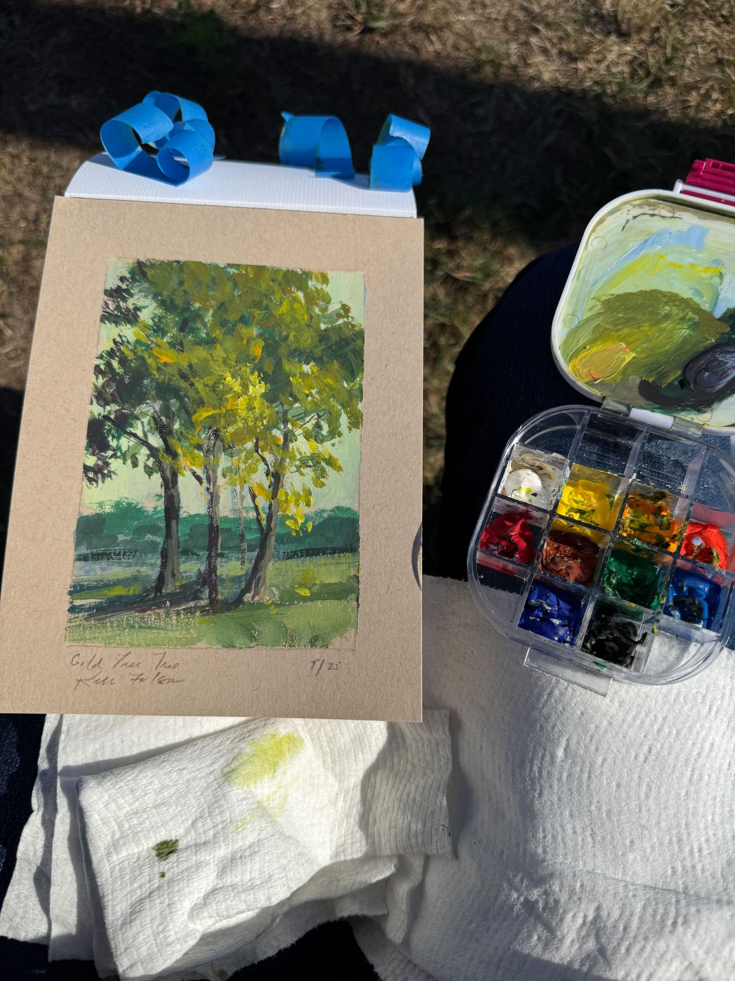 Gouache painting of three tall trees with golden-green leaves, sunlight filtering through the branches, and soft green shadows on the ground.