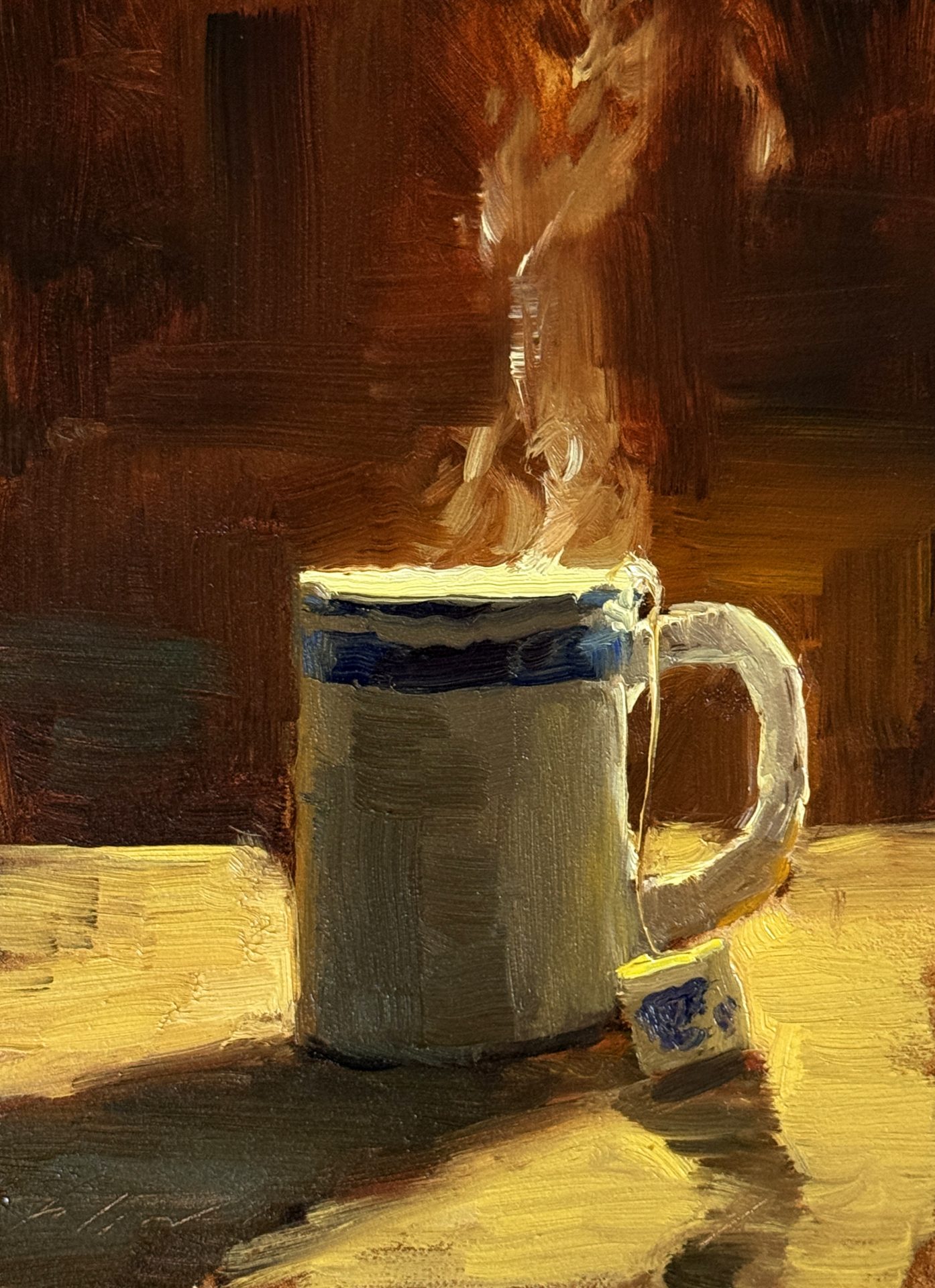 Simple Pleasures: Tea in Light, 8x6 oil still life painting by Kelli Folsom, featuring steaming cup of tea backlit against dark background on kitchen counter.