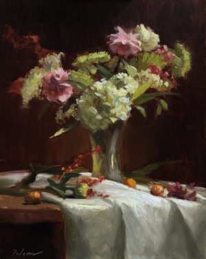 Oil painting of a floral still life featuring pink and white blooms in a glass vase, set against a dark background with scattered fruit and petals on a white draped cloth.
