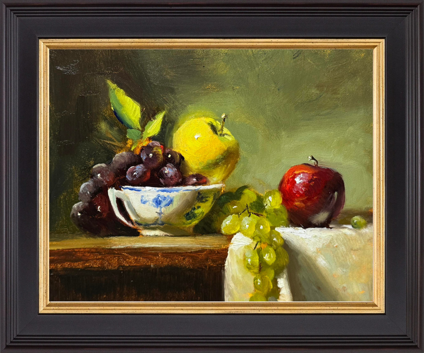 Original oil still life painting of red and green apples with green grapes and dark cherries in a blue-and-white ceramic bowl, arranged on a wooden table with soft, classical lighting.