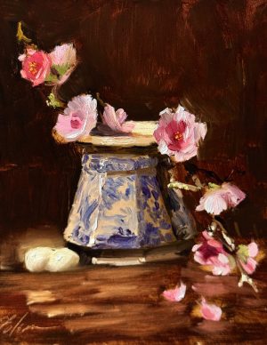 Oil painting still life of pink cherry blossoms arranged around a blue and white sugar jar with two eggs on a wooden table, set against a rich dark brown background, 8x10 oil on panel.