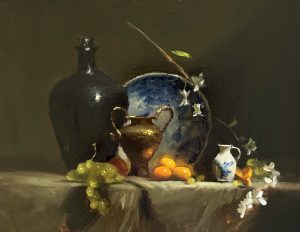 Traditional oil still life painting featuring green grapes, oranges, a dark ceramic vase, copper urn, blue decorative plate, and white blossoms arranged on a draped table with dramatic lighting.