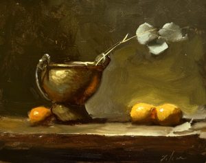 Moody oil still life featuring a polished brass vessel with eucalyptus stems beside glowing oranges on a softly lit tabletop.