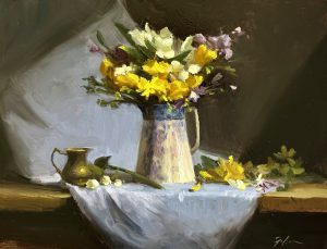Impressionist oil painting of yellow daffodils and spring flowers arranged in a white ceramic pitcher on draped white linen with a small brass vessel beside it against a dark moody background.