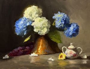 Original oil painting featuring blue and white hydrangeas arranged in a copper vase with a vintage floral teapot on a tabletop, illuminated by dramatic light.
