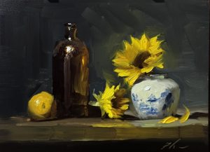 Original oil still life painting of vibrant yellow sunflowers in a blue and white ceramic vase beside an amber glass bottle and lemon, painted with bold brushstrokes against a moody dark background.